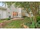 Serene backyard featuring a patio with seating, lush greenery, and a well-maintained lawn at 8013 Morrell Ln, Durham, NC 27713