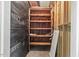 Unfinished basement space showing wooden shelving and exposed framing, ready for customization at 8013 Morrell Ln, Durham, NC 27713