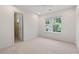 This bedroom has neutral carpet and an exterior window at 8013 Morrell Ln, Durham, NC 27713