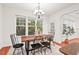 Well-lit dining room with large windows, offering scenic views and ample natural light for Gathering gatherings at 8013 Morrell Ln, Durham, NC 27713