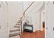Bright foyer with hardwood floors, staircase, and a view into other rooms of the home at 8013 Morrell Ln, Durham, NC 27713