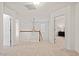 Upstairs hallway with neutral carpet, white walls, and a staircase with decorative light fixture at 8013 Morrell Ln, Durham, NC 27713