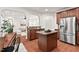 Open-concept kitchen with stainless steel appliances and granite counters, flowing into the cozy living area at 8013 Morrell Ln, Durham, NC 27713