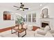 Bright living room featuring a fireplace, hardwood floors, and abundant natural light from large windows at 8013 Morrell Ln, Durham, NC 27713