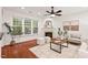 Cozy living room features hardwood floors, a fireplace, and large windows that provide ample natural light at 8013 Morrell Ln, Durham, NC 27713