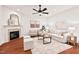 Spacious living room with hardwood floors, fireplace, and comfortable seating, perfect for relaxation at 8013 Morrell Ln, Durham, NC 27713