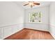 Bright office space with hardwood floors, wainscoting, and a large window offering natural light at 8013 Morrell Ln, Durham, NC 27713