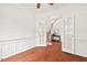 Bright office space with hardwood floors, wainscoting, and glass doors leading to the foyer at 8013 Morrell Ln, Durham, NC 27713
