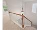 Bright staircase featuring white railing with a wooden handrail and a decorative light fixture at 8013 Morrell Ln, Durham, NC 27713