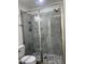 Walk in shower featuring glass doors, gray tile, and built-in shelving at 805 Da Vinci St, Durham, NC 27704
