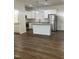 Bright, open kitchen with white cabinets, stainless steel appliances, and center island with granite countertop at 805 Da Vinci St, Durham, NC 27704