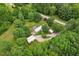 A home nestled among a tree covered area with various outbuildings at 8089 Crawford Currin Rd, Oxford, NC 27565