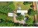 Sprawling property showcases a residence, outbuildings, and natural tree coverage at 8089 Crawford Currin Rd, Oxford, NC 27565