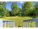 Expansive backyard view from the deck, showcasing the lush greenery and serene landscape at 8089 Crawford Currin Rd, Oxford, NC 27565