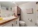 A well-lit bathroom featuring a wood countertop vanity and white toilet at 8089 Crawford Currin Rd, Oxford, NC 27565
