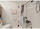 Bright bathroom featuring a white tiled shower, toilet and built-in shelving at 8089 Crawford Currin Rd, Oxford, NC 27565