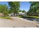 Traditional home featuring a gravel driveway, carport, and well-manicured front lawn at 8089 Crawford Currin Rd, Oxford, NC 27565