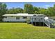 Charming single-story home with a spacious deck and a lush green lawn at 8089 Crawford Currin Rd, Oxford, NC 27565
