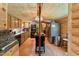 Rustic kitchen featuring wood cabinets, an island, black appliances, and wood flooring at 8089 Crawford Currin Rd, Oxford, NC 27565