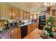 Well-lit rustic kitchen with wooden cabinets, black appliances, and plenty of counter space at 8089 Crawford Currin Rd, Oxford, NC 27565