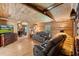Inviting living room with wood paneled walls, hardwood floors, and leather sofas at 8089 Crawford Currin Rd, Oxford, NC 27565