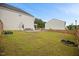 Large, grassy backyard with a dining set, fire pit, and fenced perimeter for privacy at 95 Buckthorn Dr, Youngsville, NC 27596