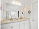 Bathroom featuring double sinks, granite countertops, and decorative wall accents at 95 Buckthorn Dr, Youngsville, NC 27596