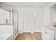 Bright bathroom featuring double doors, marble counters, tile floors, and a shower at 95 Buckthorn Dr, Youngsville, NC 27596