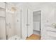 Bright bathroom featuring walk-in shower, and tile walls at 95 Buckthorn Dr, Youngsville, NC 27596
