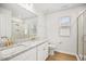 Bright bathroom featuring double sinks, granite countertops, white cabinets, and a walk-in shower at 95 Buckthorn Dr, Youngsville, NC 27596