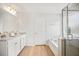 Bathroom with double granite sinks, soaking tub and glass enclosed shower at 95 Buckthorn Dr, Youngsville, NC 27596