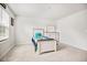 Bedroom with large window, dresser, bed, and neutral colored carpet at 95 Buckthorn Dr, Youngsville, NC 27596