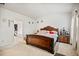 Bright bedroom featuring carpeted floors, white walls and trim, a bed, and nightstand at 95 Buckthorn Dr, Youngsville, NC 27596