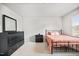 Bright bedroom featuring carpeted floors, white walls and trim, a bed, and a dresser at 95 Buckthorn Dr, Youngsville, NC 27596