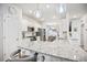Granite countertop island kitchen featuring stainless steel appliances, pendant lighting, and sleek fixtures at 95 Buckthorn Dr, Youngsville, NC 27596