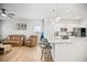 Open floor plan showcases a kitchen with a granite island, modern lighting, and seamless living space integration at 95 Buckthorn Dr, Youngsville, NC 27596