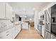 Modern kitchen with white cabinets, stainless steel appliances, granite countertops, and an open layout at 95 Buckthorn Dr, Youngsville, NC 27596