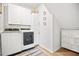 Convenient laundry room features modern washer and dryer, ample storage, and stylish decor at 95 Buckthorn Dr, Youngsville, NC 27596