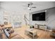 Open concept living area features hardwood floors, a modern ceiling fan, and a view of the kitchen at 95 Buckthorn Dr, Youngsville, NC 27596