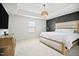 Bright main bedroom featuring decorative wall, carpet, and pendant lighting above a large bed at 95 Buckthorn Dr, Youngsville, NC 27596
