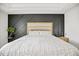 Close up of a large bed in the main bedroom, with a decorative wall behind it at 95 Buckthorn Dr, Youngsville, NC 27596