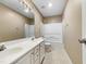 Bathroom featuring dual sinks, a large mirror, and a shower-tub combo at 1005 Augustine Trl, Cary, NC 27518