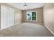Bright bedroom with carpet, a window, and a double door closet at 1005 Augustine Trl, Cary, NC 27518