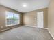 Cozy bedroom with neutral carpet, a window, and a practical closet door at 1005 Augustine Trl, Cary, NC 27518