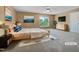 Comfortable bedroom with a ceiling fan, plush carpet, and ample natural light at 1005 Augustine Trl, Cary, NC 27518