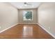 Bedroom with hardwood floors, neutral walls, and bright natural light at 1005 Augustine Trl, Cary, NC 27518