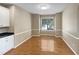 Bright dining room featuring hardwood floors, neutral walls, and a sunlit window at 1005 Augustine Trl, Cary, NC 27518