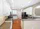 Well-appointed kitchen featuring white cabinets, grey countertops, and stainless steel appliances at 1005 Augustine Trl, Cary, NC 27518