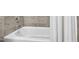 Bathroom showcasing a clean bathtub with chrome fixtures and neutral tile surround, providing a simple and functional bathing space at 102 Bella Rose Drive, Chapel Hill, NC 27517