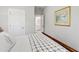 Bedroom featuring a bed with neutral bedding, a door leading to a bathroom, and warm decor, creating a cozy and inviting space at 102 Bella Rose Drive, Chapel Hill, NC 27517